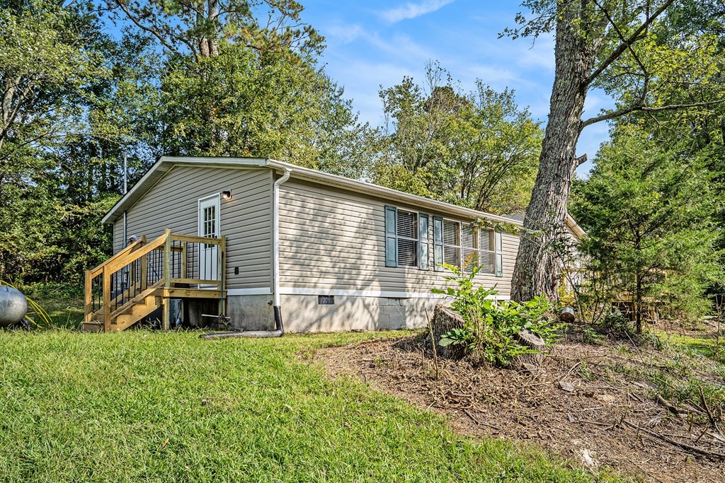 359 Norton Bridge Road Chatsworth, GA 30705 - Photo 26 of 28 a front view of a house with garden