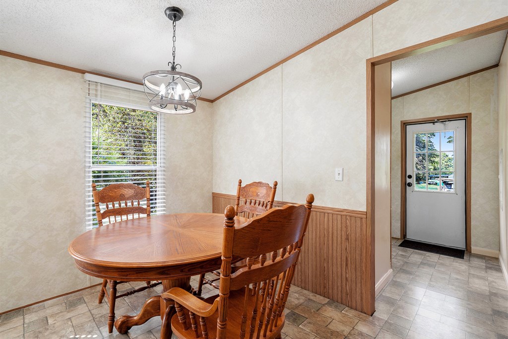 359 Norton Bridge Road Chatsworth, GA 30705 - Photo 10 of 28 a view of a dining room with furniture window and wooden floor