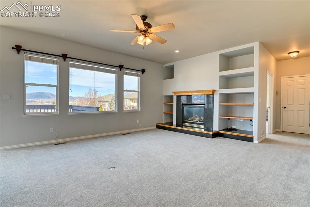 Undisclosed Address Colorado Springs, CO 80921 - Photo 33 of 49 a view of an empty room with a fireplace and a window