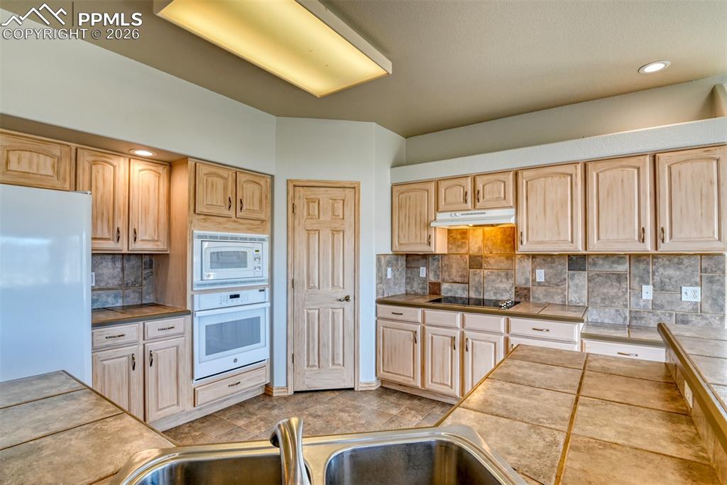 Undisclosed Address Colorado Springs, CO 80921 - Photo 5 of 49 a kitchen with stainless steel appliances granite countertop a stove a sink and a refrigerator