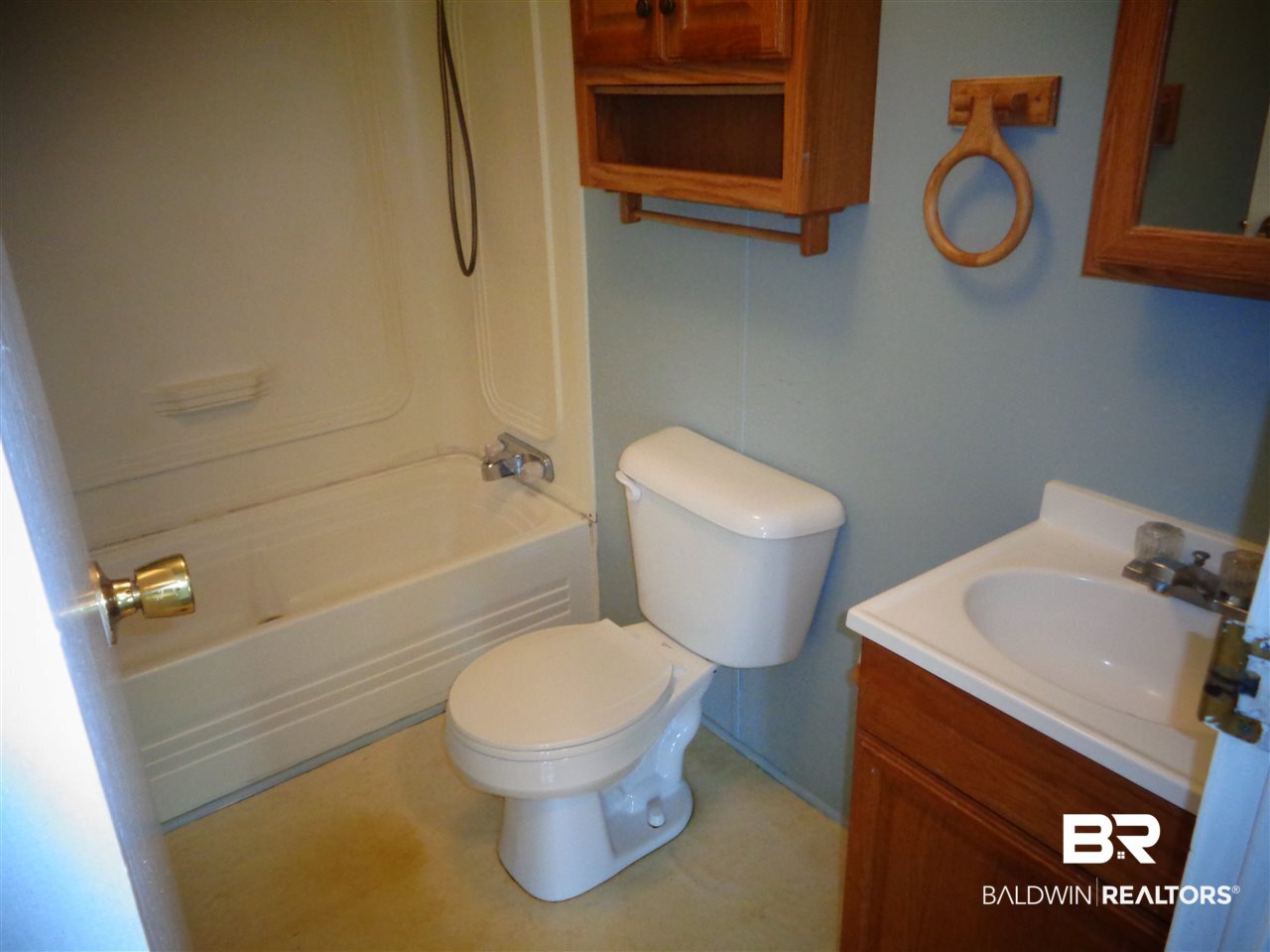 21535 A Glass And Spivey Road Robertsdale, AL 36567 - Photo 5 of 32 Single vanity, medicine cabinet. Tub/shower.