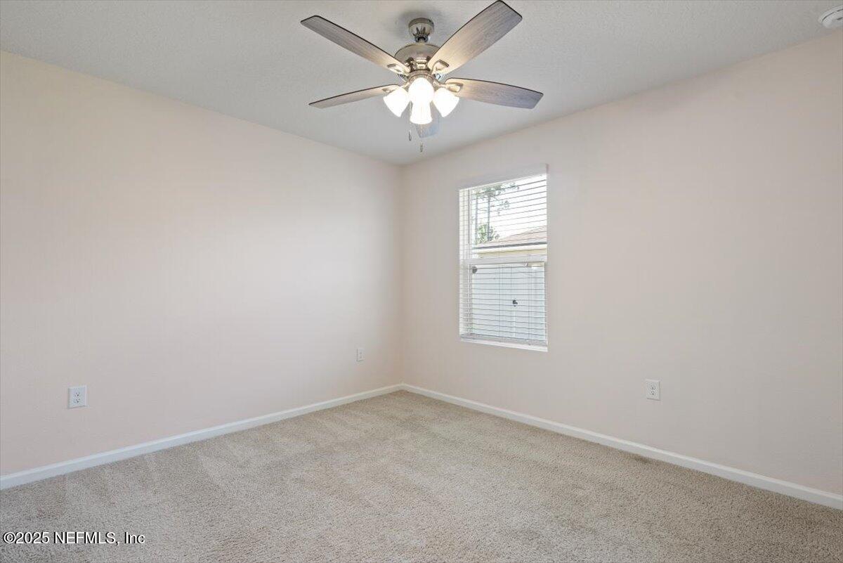 88 North Hamilton Springs Road St. Augustine, FL 32084 - Photo 11 of 73 an empty room with windows and fan