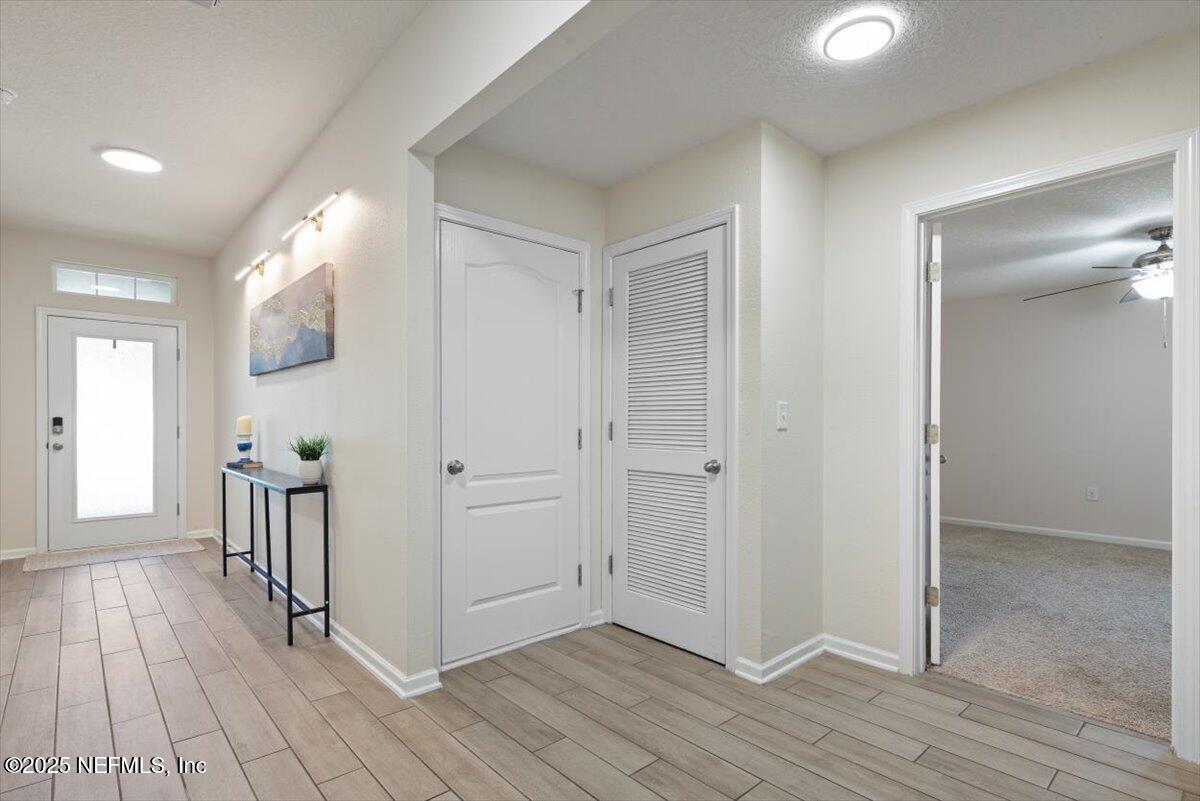 88 North Hamilton Springs Road St. Augustine, FL 32084 - Photo 13 of 73 a view of a hallway with wooden floor and staircase