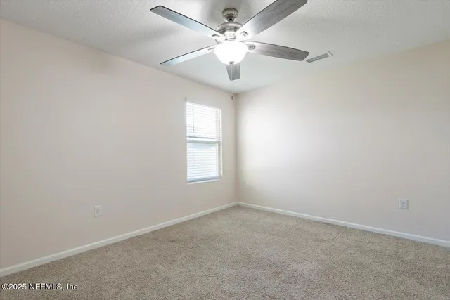 a kitchen with stainless steel appliances granite countertop a stove a sink a microwave a refrigerator and white cabinets with wooden floor