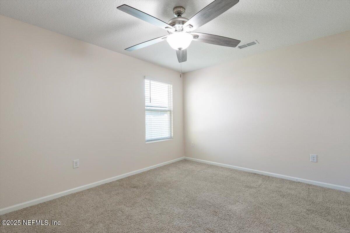 88 North Hamilton Springs Road St. Augustine, FL 32084 - Photo 14 of 73 an empty room with a window and a fan
