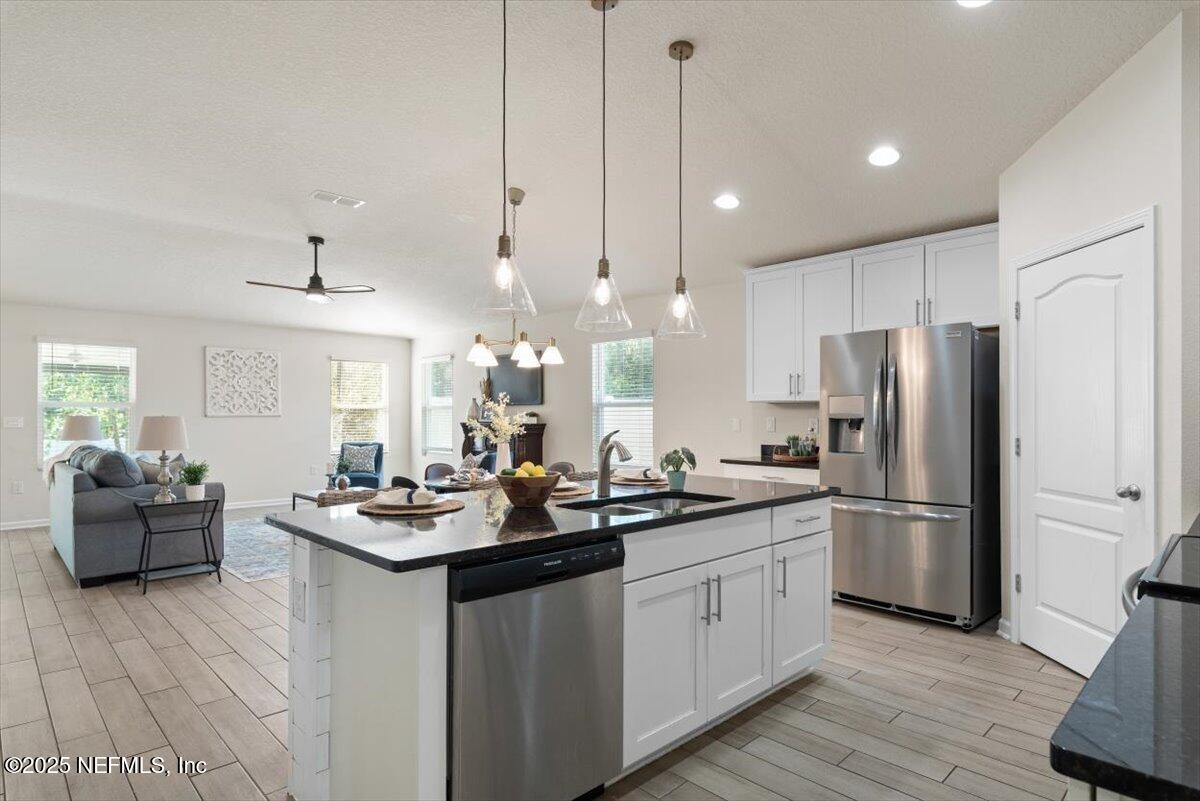 88 North Hamilton Springs Road St. Augustine, FL 32084 - Photo 16 of 73 a kitchen with a refrigerator a stove a sink dishwasher with a dining table and chairs