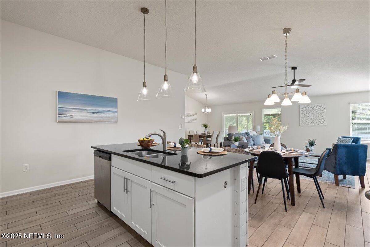 88 North Hamilton Springs Road St. Augustine, FL 32084 - Photo 19 of 73 a view of a dining room and livingroom with furniture wooden floor a chandelier