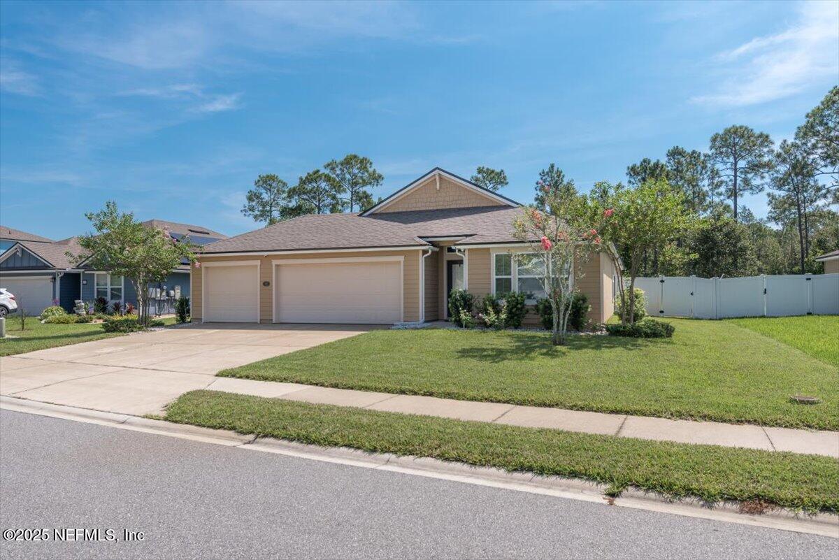 88 North Hamilton Springs Road St. Augustine, FL 32084 - Photo 2 of 73 a front view of a house with a yard and garage