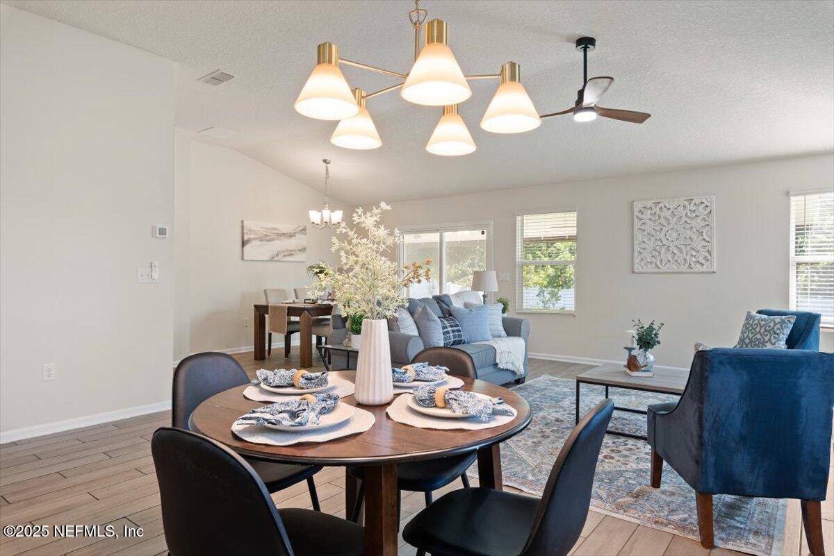 88 North Hamilton Springs Road St. Augustine, FL 32084 - Photo 21 of 73 a view of a dining room with furniture and chandelier