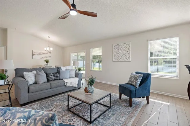 a living room with furniture and a chandelier