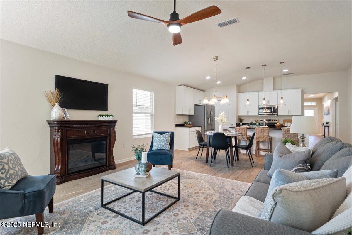 88 North Hamilton Springs Road St. Augustine, FL 32084 - Photo 27 of 73 a living room with furniture a fireplace and a flat screen tv