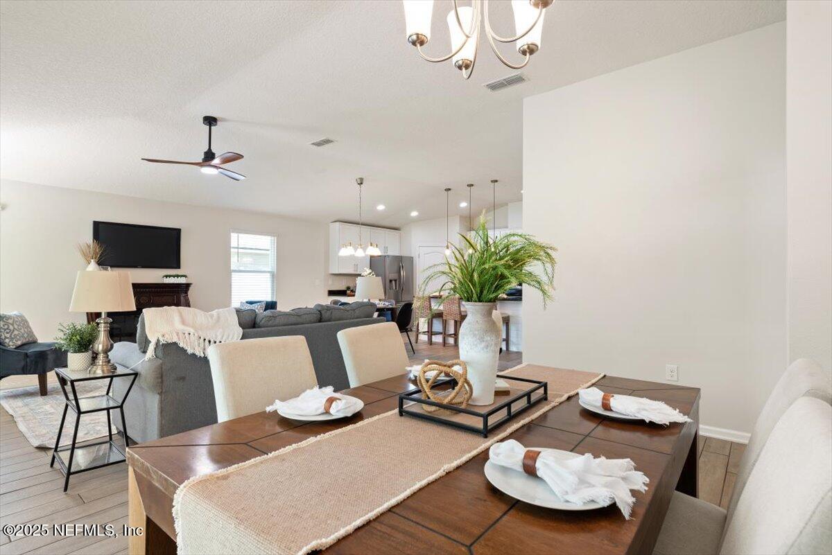 88 North Hamilton Springs Road St. Augustine, FL 32084 - Photo 28 of 73 a living room with furniture and a chandelier