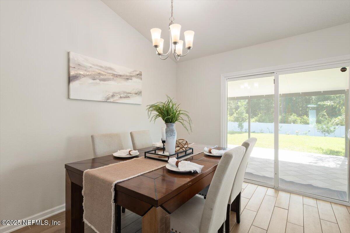 88 North Hamilton Springs Road St. Augustine, FL 32084 - Photo 29 of 73 a view of a dining room with furniture a chandelier and wooden floor