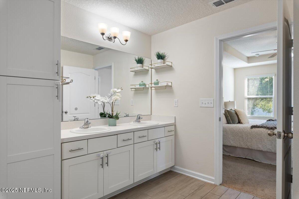 88 North Hamilton Springs Road St. Augustine, FL 32084 - Photo 35 of 73 a en suite bathroom with a double vanity sink and mirror