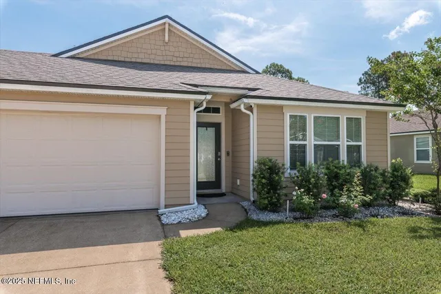 a front view of a house with garden
