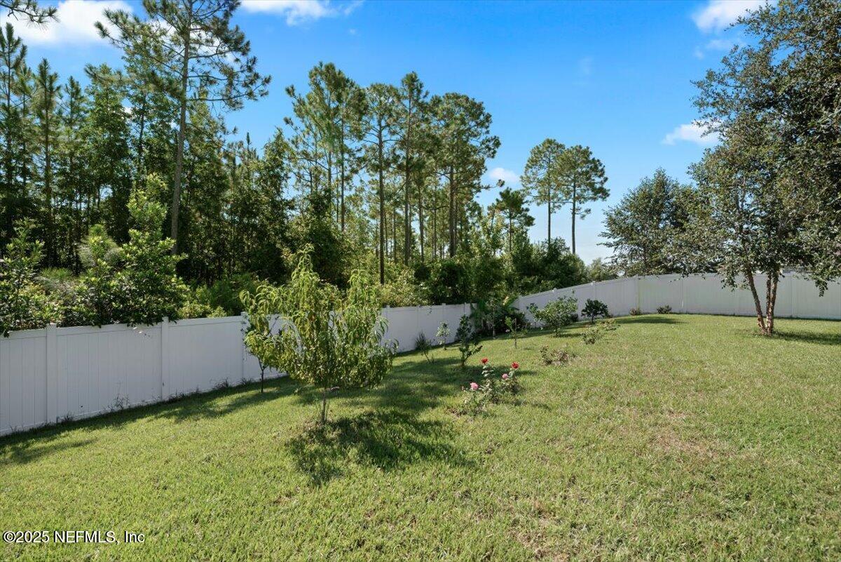 88 North Hamilton Springs Road St. Augustine, FL 32084 - Photo 43 of 73 a backyard of a house with a yard and outdoor seating