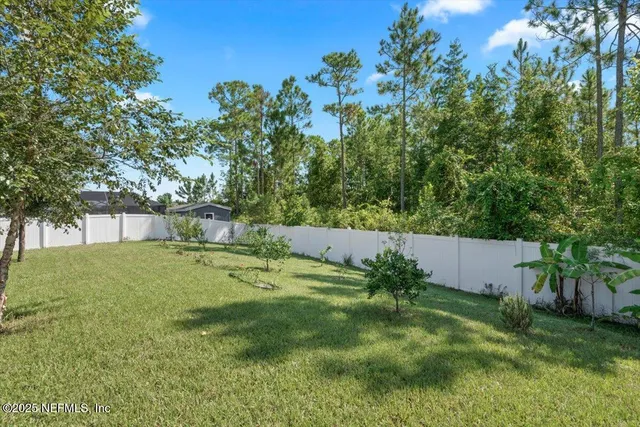 a aerial view of a house with a yard