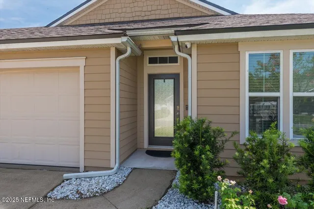 a view of entryway of house with potted plants