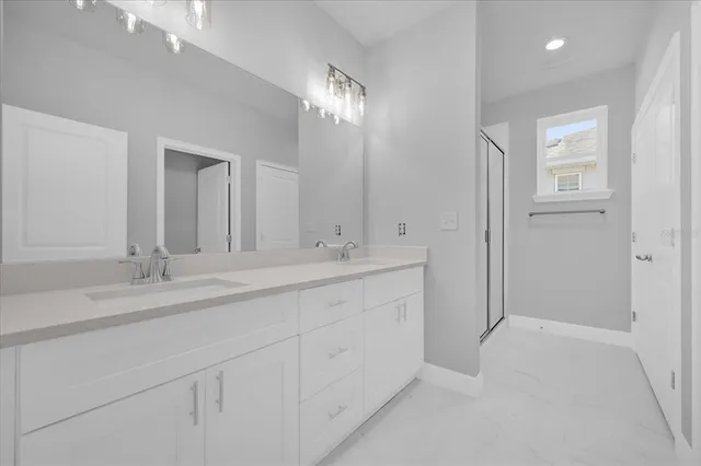 a bathroom with double sink and a mirror