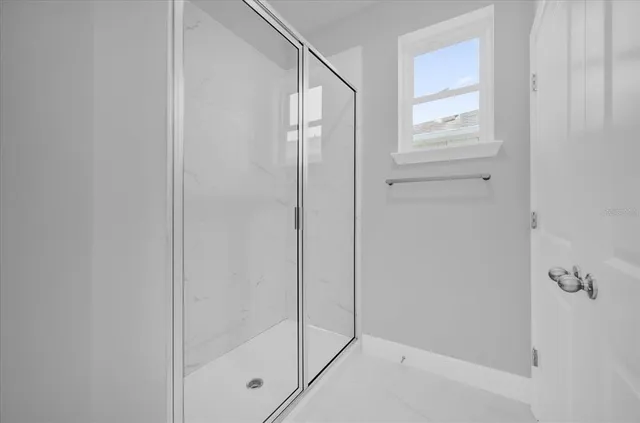 a bathroom with a glass shower door