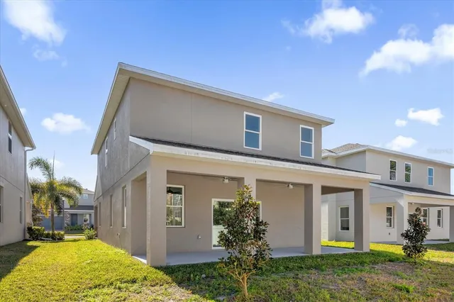 a view of a porch with furniture and a yard