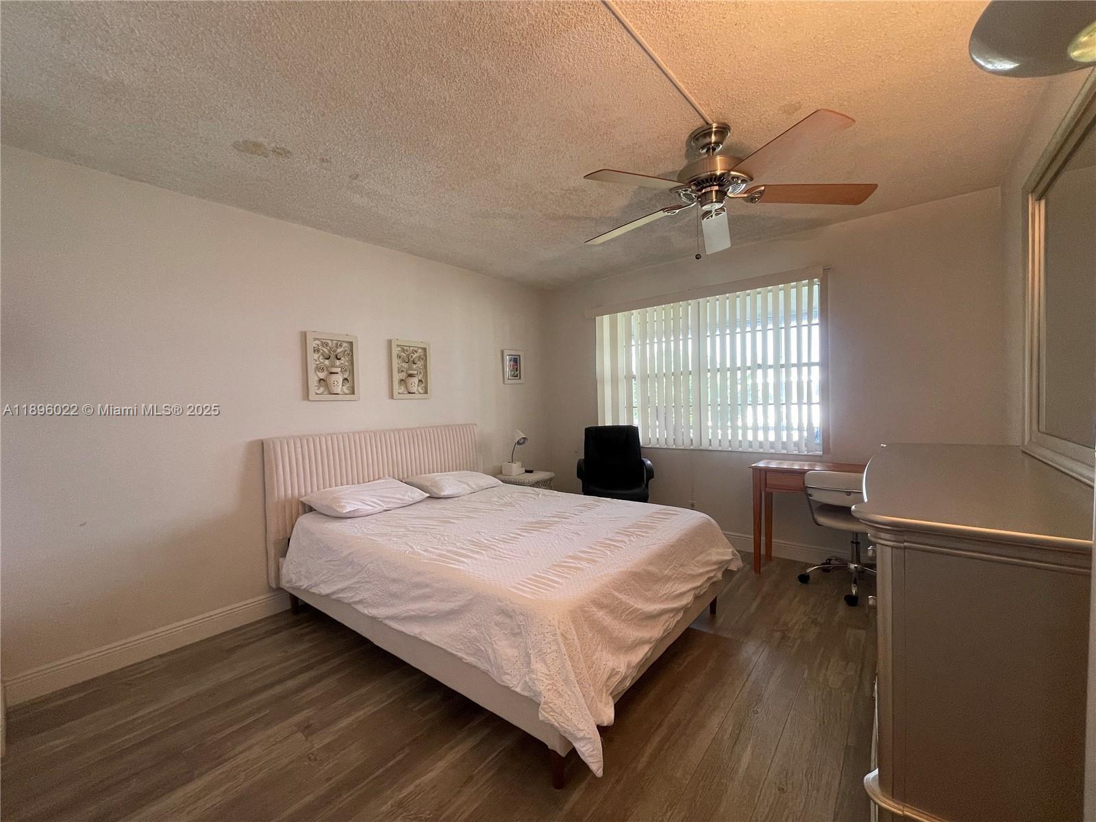 279 Markham M, Unit M Deerfield Beach, FL 33442 - Photo 4 of 15 a bedroom with a bed and a window