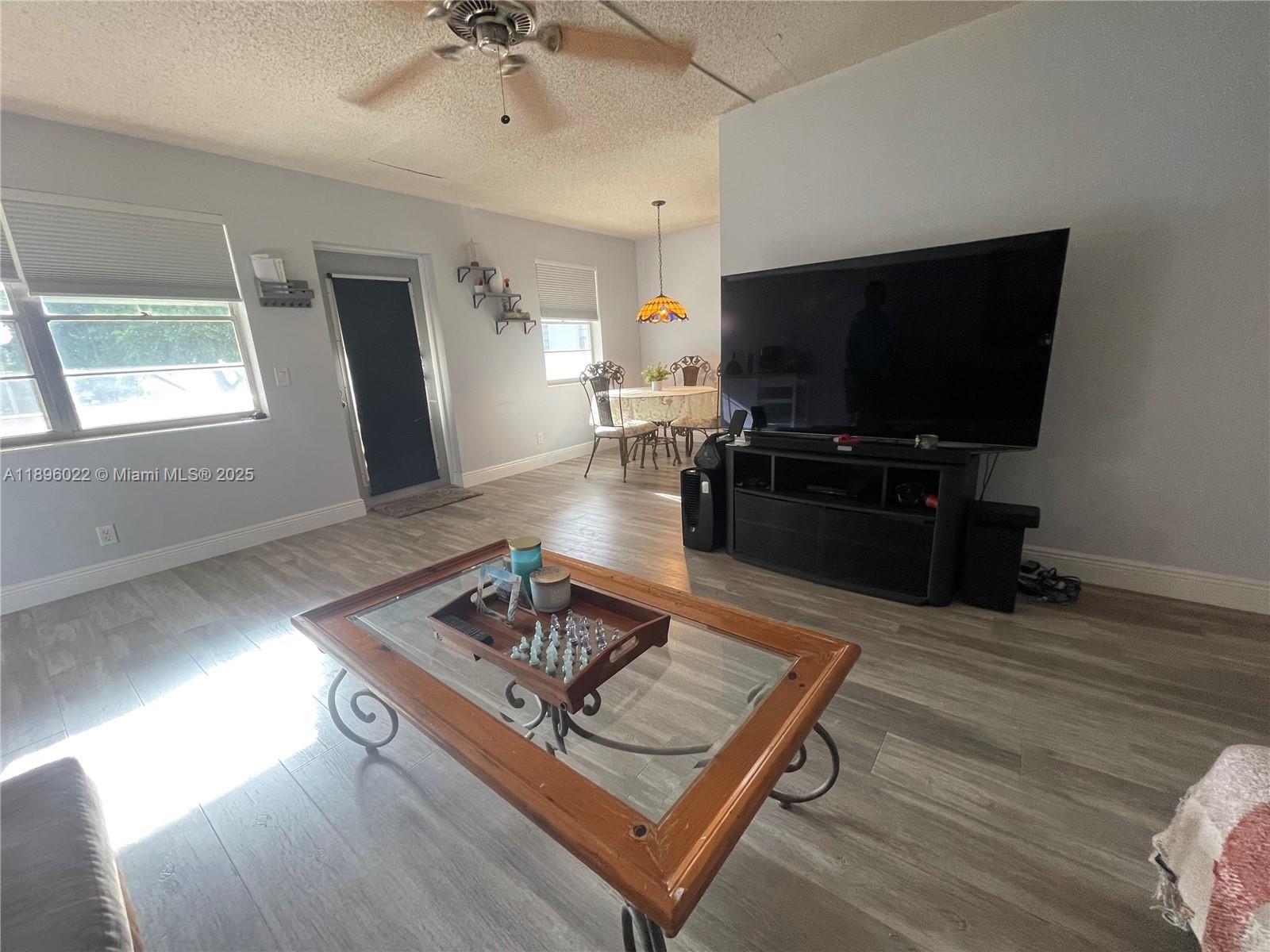 279 Markham M, Unit M Deerfield Beach, FL 33442 - Photo 8 of 15 a living room with furniture and a flat screen tv