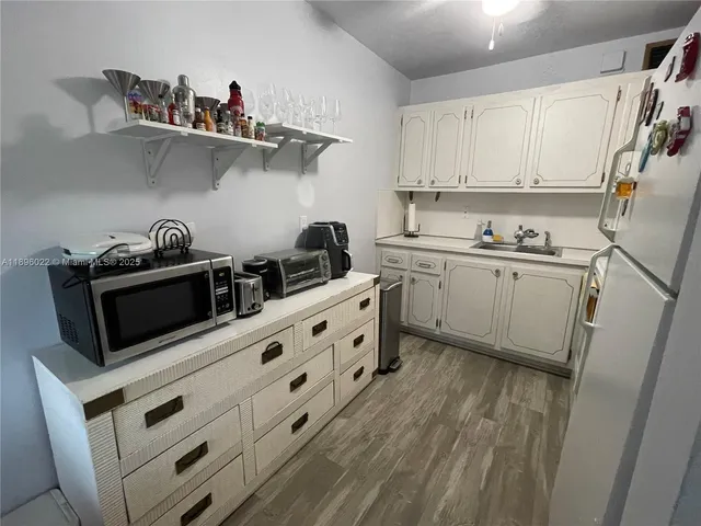 a kitchen with appliances cabinets and a sink