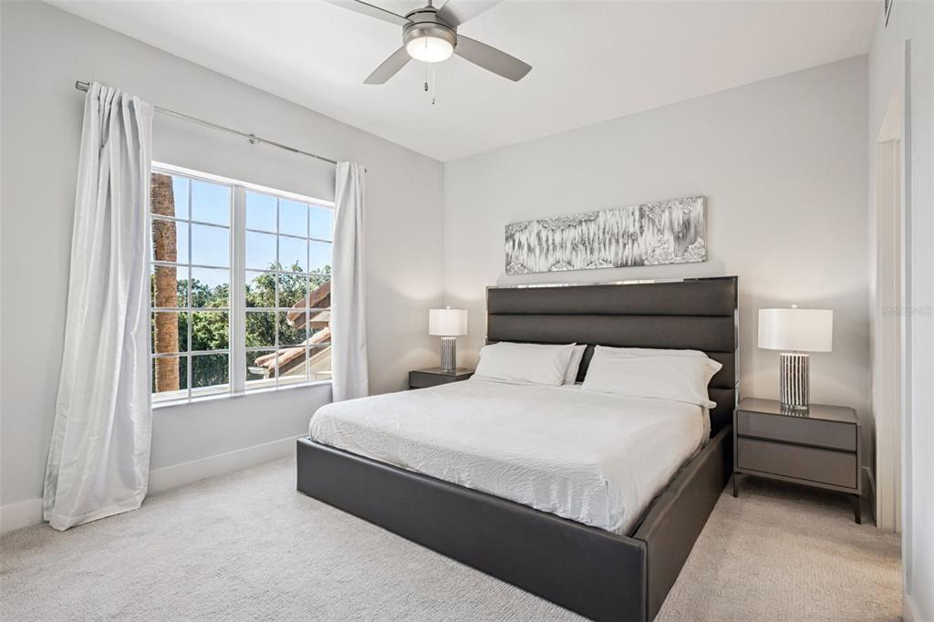 8774 Worldquest Boulevard, Unit 7307 Orlando, FL 32821 - Photo 23 of 52 a bedroom with a large bed and a window