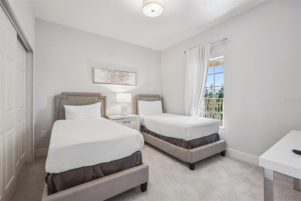 8774 Worldquest Boulevard, Unit 7307 Orlando, FL 32821 - Photo 27 of 52 a spacious bedroom with a bed and window