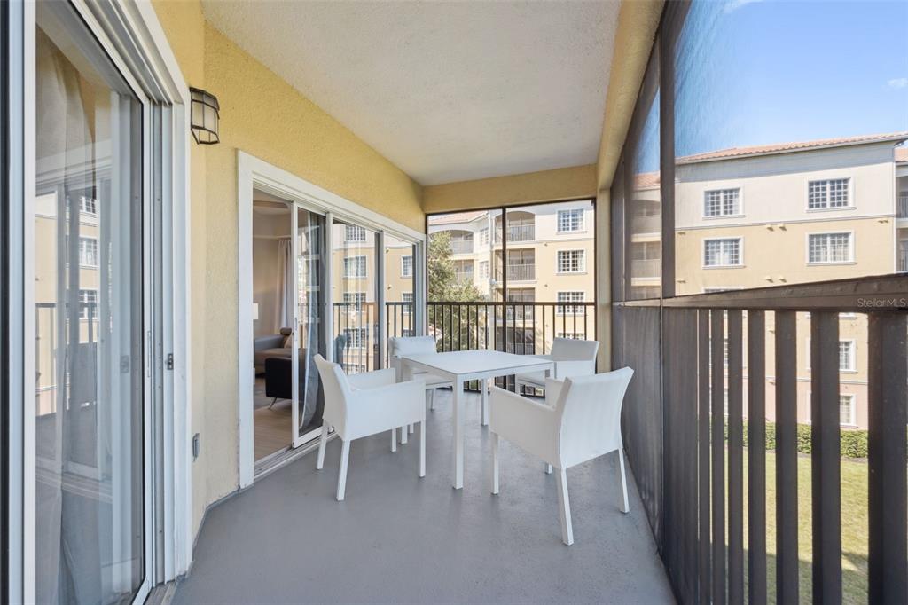 8774 Worldquest Boulevard, Unit 7307 Orlando, FL 32821 - Photo 31 of 52 a view of a dining room with furniture large windows and wooden floor