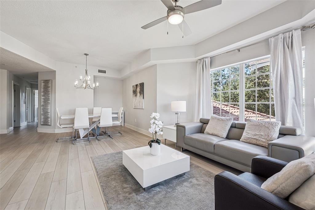 8774 Worldquest Boulevard, Unit 7307 Orlando, FL 32821 - Photo 5 of 52 a living room with furniture and a large window