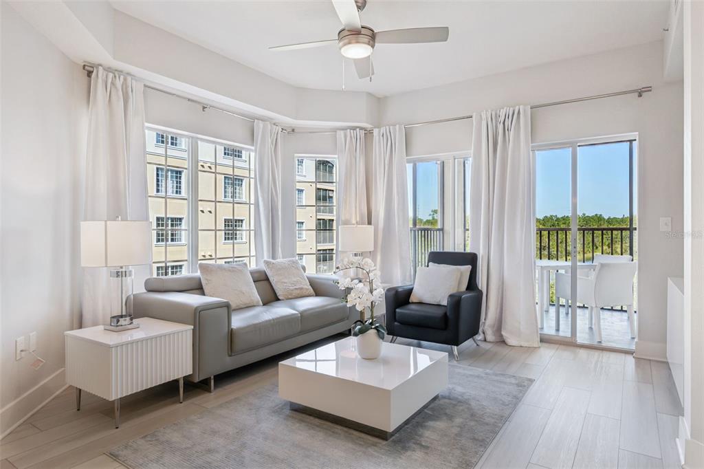 8774 Worldquest Boulevard, Unit 7307 Orlando, FL 32821 - Photo 6 of 52 a living room with furniture and a large window