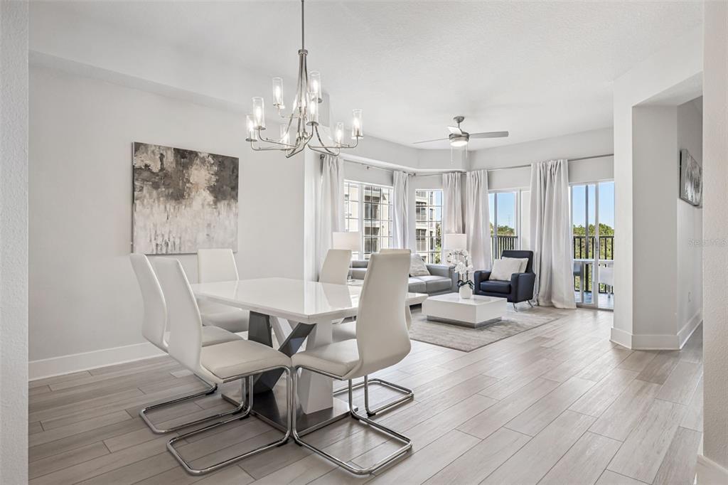 8774 Worldquest Boulevard, Unit 7307 Orlando, FL 32821 - Photo 8 of 52 a view of a dining room with furniture window and wooden floor