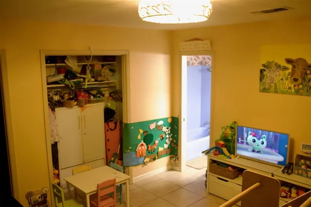 a living room with a couch and a table with potted plants