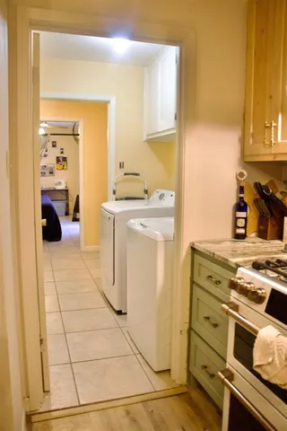 a kitchen with a stove top oven and cabinets
