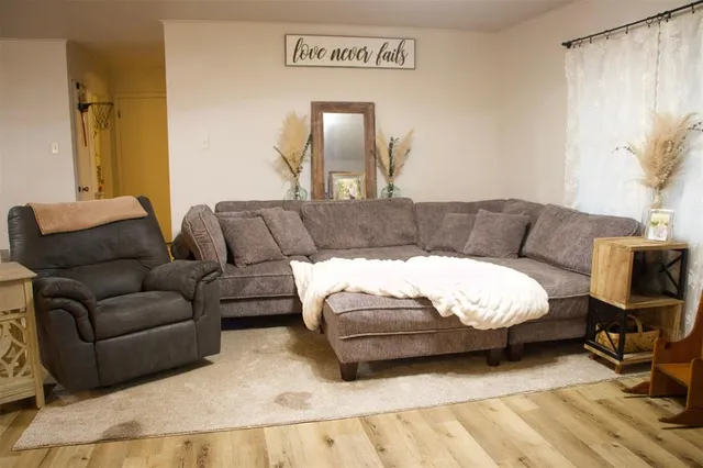 a living room with furniture and a mirror