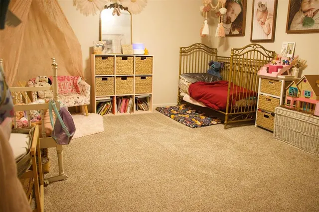 a view of a bedroom with furniture and a window