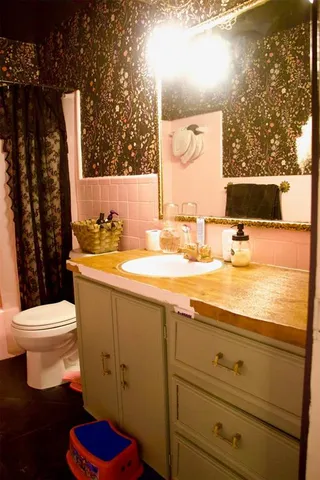 a bathroom with a toilet and a shower curtain