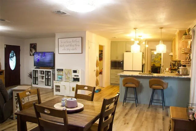 a living room with furniture a rug and a painting