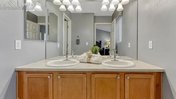 a bathroom with a sink vanity and a mirror
