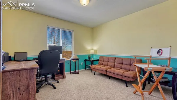 a livingroom with workspace and a couch
