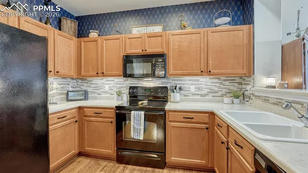 a kitchen with a sink stove and cabinets