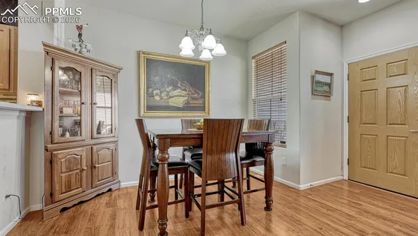 a view of a dining room with furniture wooden floor and chandelier