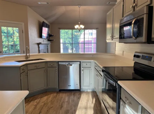 a kitchen with a sink stove and microwave