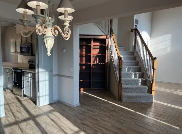 a view of entryway and hall with wooden floor