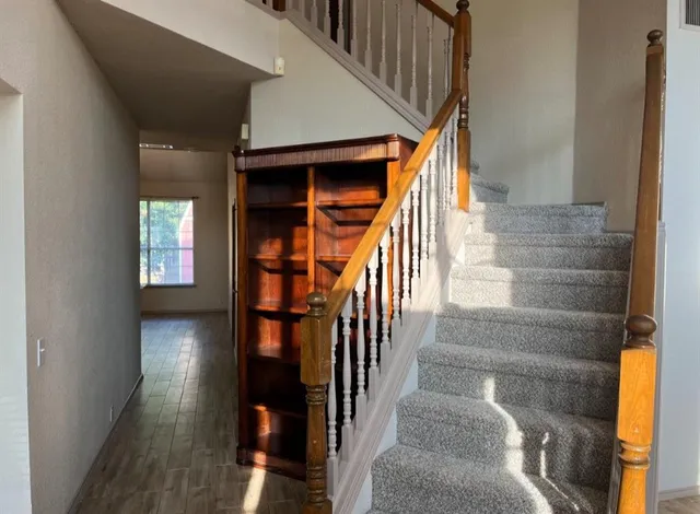 a view of entryway and hall with wooden floor