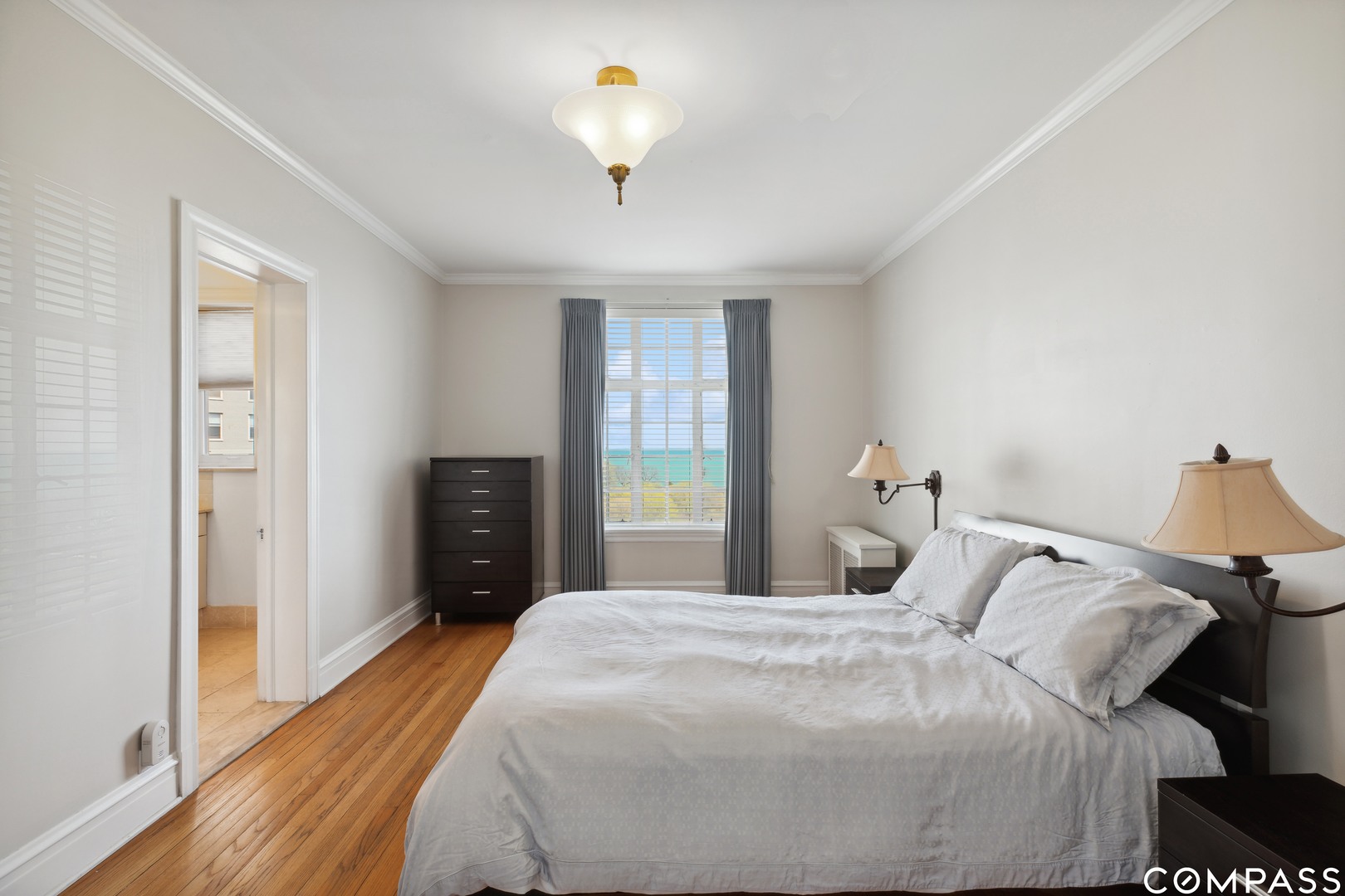 Undisclosed Address Chicago, IL 60613 - Photo 13 of 19 a bedroom with a bed and a chandelier