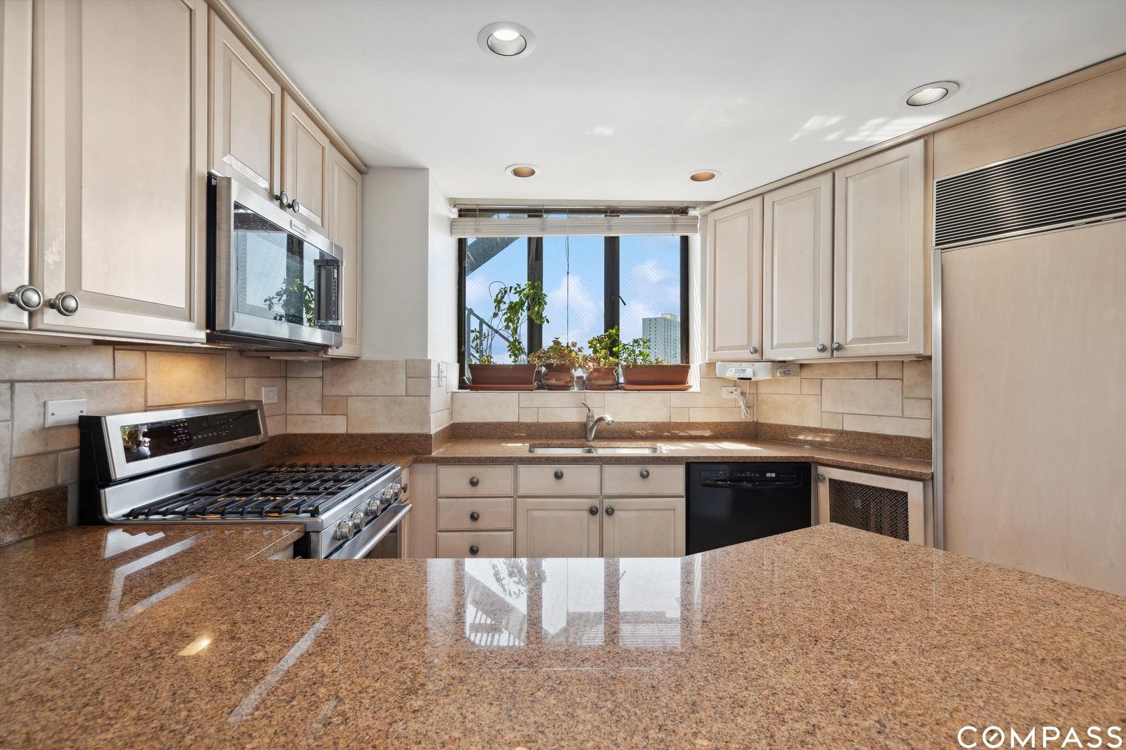 Undisclosed Address Chicago, IL 60613 - Photo 10 of 19 a kitchen with stainless steel appliances granite countertop a stove a sink and a refrigerator