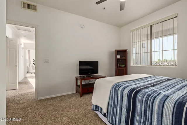 a bedroom with a bed and a television